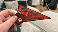 a person is holding a pennant with the words'the street dreamers'on it